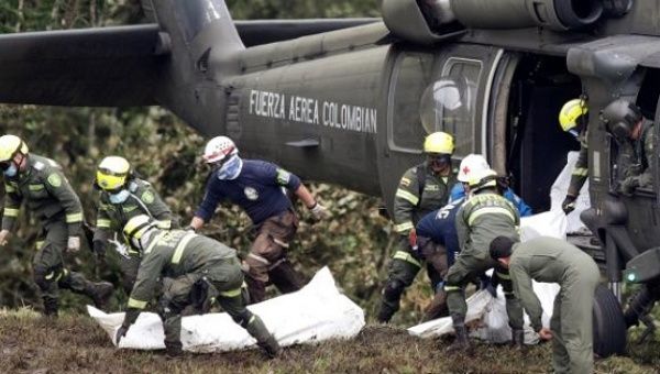 A Colombian air force helicopter retrieves the bodies of victims from the wreckage of a plane that crashed near Medellin, Colombia, Nov. 29, 2016. 