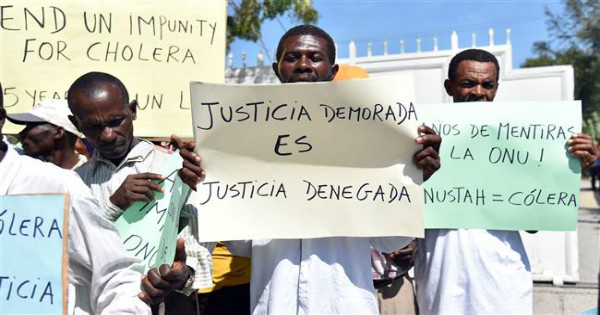 'Justice Delayed Is Justice Denied' Haitian activists and cholera victims protest the UN Stabilization Mission in the capital, Port-au-Prince