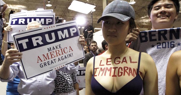 A protestor opposed to U.S. Republican presidential candidate Donald Trump's stance on immigration clashes with Trump supporters at a rally in Norcross, Georgia.