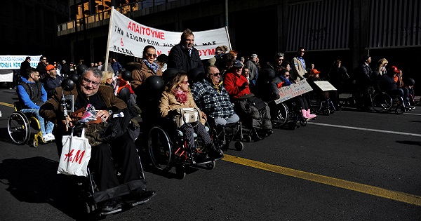 Demonstrators with physical disabilities take part in a protest calling on the government not to cut down their monthly disability subsidy and pension, in Athens, Greece, Dec. 2, 2016.