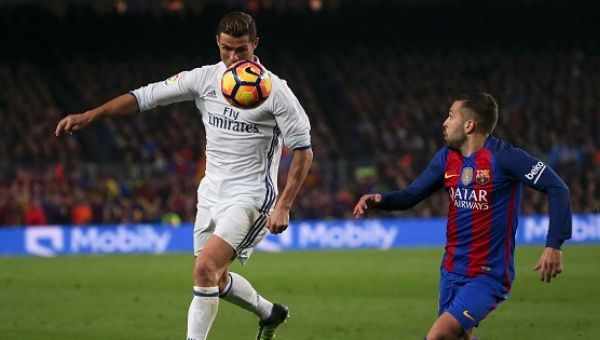 Real Madrid's Cristiano and Barcelona's Jordi Alba in action at the Nou Camp Stadium, Barcelona, Spain
