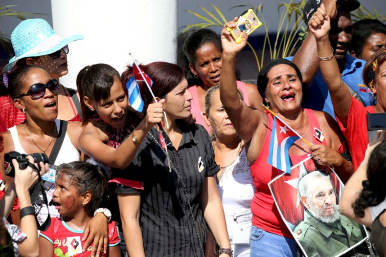 Residents react as the caravan carrying the ashes of Cuba's late President Fidel Castro arrives in Santiago de Cuba, Dec. 3, 2016. 