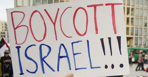 Demonstrator holds a sign at BDS protest.