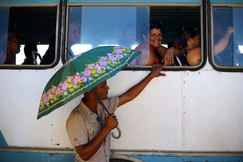 Passengers sit on a bus near the estate where Cuba's former President Fidel Castro was born, in Biran.