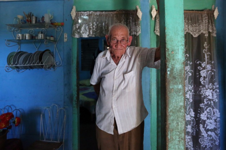 Martin Castro, half-brother of Cuba's former President Fidel Castro, poses for a photograph at his home in Biran.