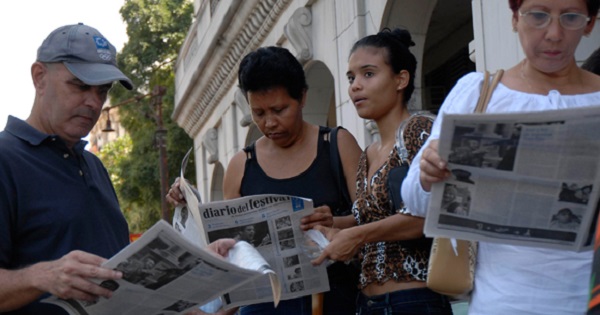 People read the Festival newspaper outside the Payret movie theater in Havana, Cuba, Dec. 6, 2008.
