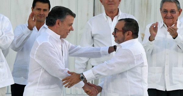 Colombian President Santos (L) and FARC leader Timoleón Jiménez (R) shake hands upon signing the first Peace agreement in Havana, Cuba Sept. 25, 2016