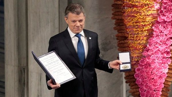 Nobel Peace Prize laureate Colombian President Juan Manuel Santos poses with the medal and diploma during the Peace Prize awarding ceremony at the City Hall in Oslo, Norway December 10, 2016. 