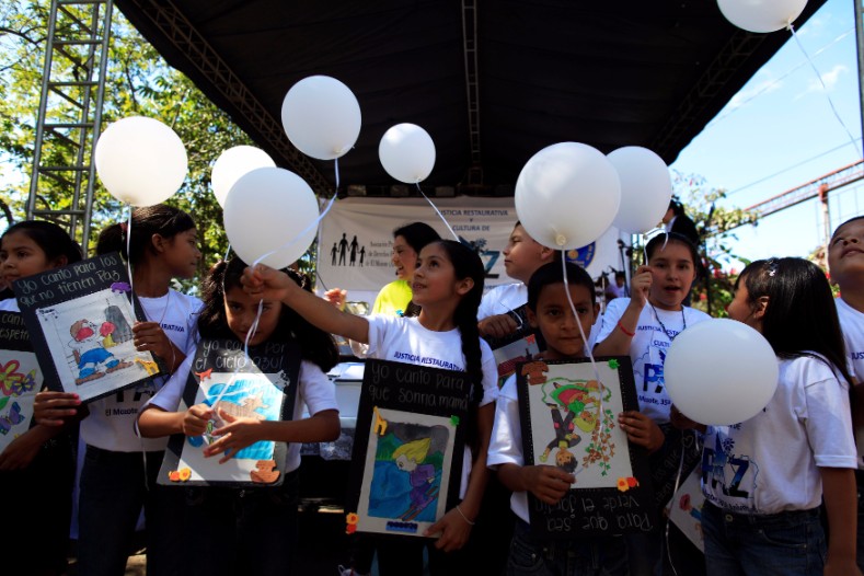 Children participate in a ceremony to commemorate El Mozote victims.