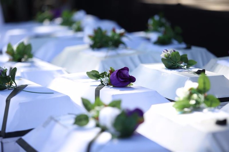 Family members of victims whose remains have been identified presented 21 white coffins of their remains as part of the events to commemorate the 35th anniversary of the massacre.
