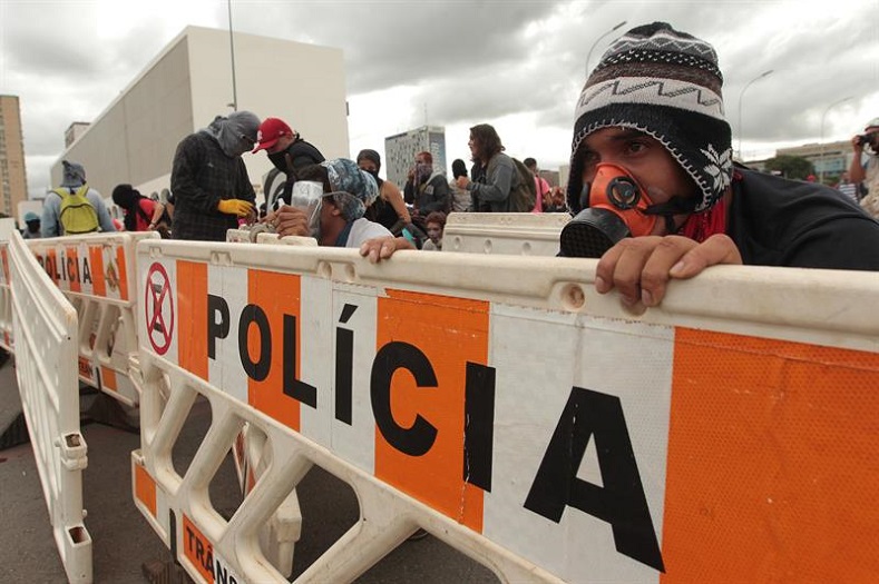 Protesters face off against riot police at the Explanada de Ministerios, the principal avenue of government buildings and ministries.
