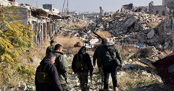 Syrian pro-government forces walk amidst the rubble in old Aleppo's Jdeideh neighborhood, Dec.