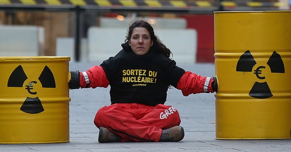 An activist blocks the entrance of the France's electricity company EDF headquarters to protest against nuclear energy safety, Paris, Dec. 14, 2016.