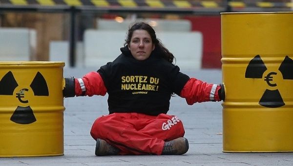 An activist blocks the entrance of the France's electricity company EDF headquarters to protest against nuclear energy safety, Paris, Dec. 14, 2016. 