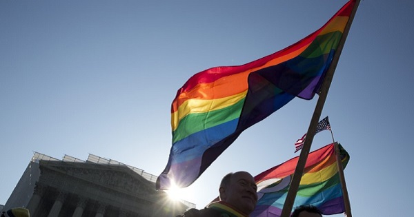 Supporters of gay marriage hold rainbow-colored flags as they rally in front of the Supreme Court in Washington.