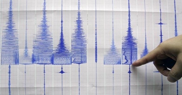 A seismologist points at a graphic showing an earthquake reading at the Central Weather Bureau in Taipei, July 14, 2009.