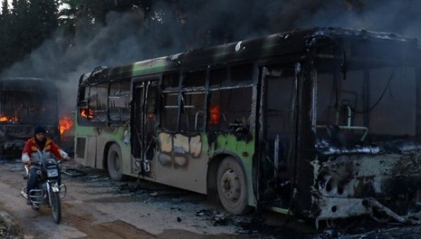 The buses were burned while en route to evacuate ill and injured people from the besieged Syrian villages of al-Foua and Kefraya, in Idlib province, Dec. 18, 2016. 