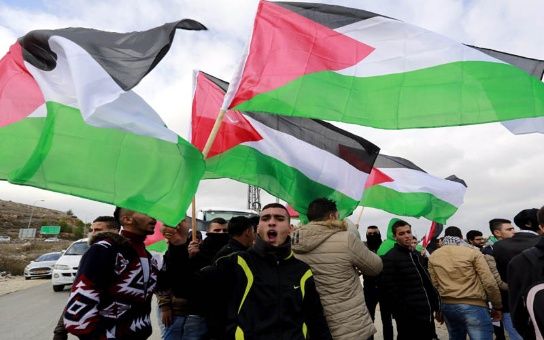 Palestinians take to the streets to celebrate the U.N. denunciation of illegal settlements.