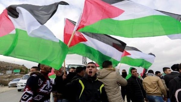Palestinians take to the streets to celebrate the U.N. denunciation of illegal settlements.
