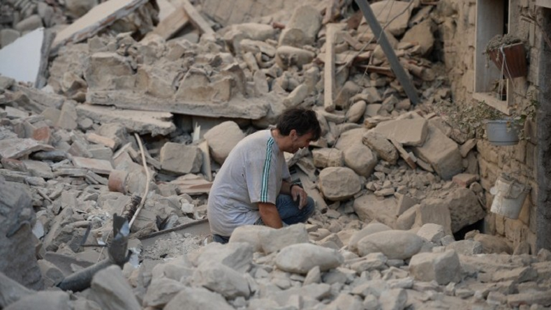 A man reacts to his damaged home after a strong earthquake hit Amatrice on August 24. Italy's most powerful earthquake in 36 years stuck the country's mountainous center on Oct. 30. 