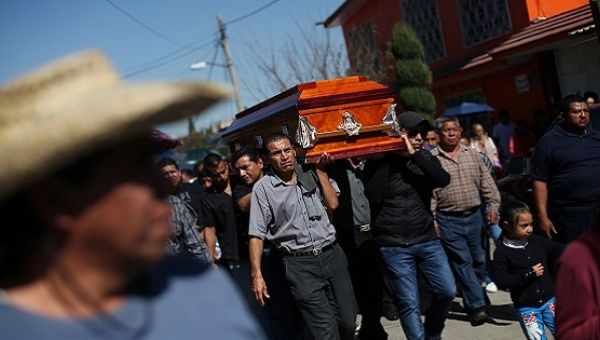 Relatives and friends accompany the coffin of a victim of an explosion at a popular fireworks market on Mexico City's outskirts, in Tultepec, December 22, 2016. 