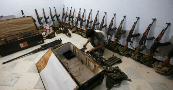 A rebel fighter of 'Al-Sultan Murad' brigade arranges weapons inside a warehouse in the northern Syrian rebel-controlled town of al-Rai, in Aleppo Governorate, Syria, Sep. 26, 2016.