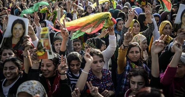 Kurdish people attend a celebration rally near the Turkish-Syrian border at Suruc, in Sanliurfa province on January 27, 2015 after Kurdish fighters expelled Islamic State group militants from the Syrian border town of Kobane.