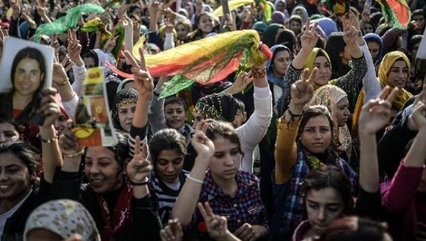 Kurdish people attend a celebration rally near the Turkish-Syrian border at Suruc, in Sanliurfa province on January 27, 2015 after Kurdish fighters expelled Islamic State group militants from the Syrian border town of Kobane.
