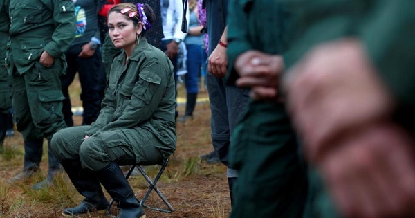 A fighter from FARC seats during the opening of ceremony congress at the camp where they prepare for ratifying a peace deal with the government.