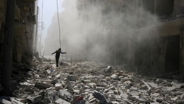 A man walks on the rubble of damaged buildings after an airstrike on the rebel held al-Qaterji neighbourhood of Aleppo, Syria Sept. 25, 2016.