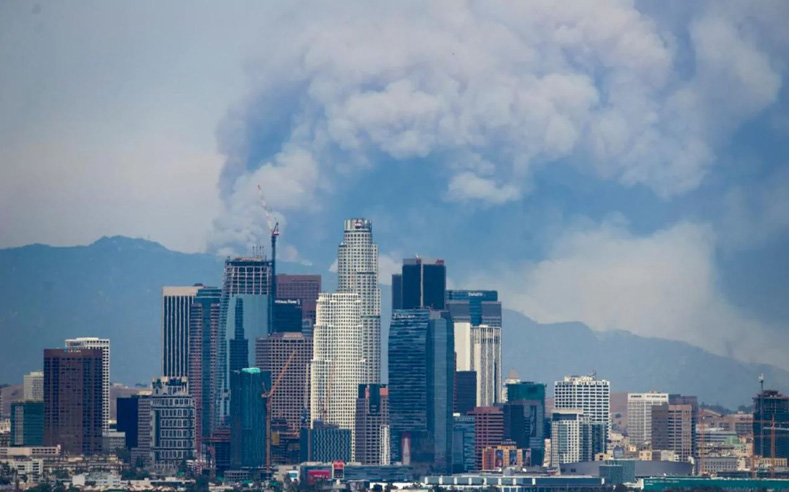 Smoke towers over Los Angeles skyline as fresh wildfires erupted across California during the summer. 