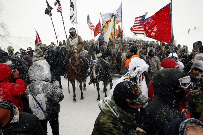 Veterans march with activists near Backwater Bridge just outside the Oceti Sakowin camp adjacent to the Standing Rock Indian Reservation, near Cannon Ball, North Dakota, December 5, 2016.