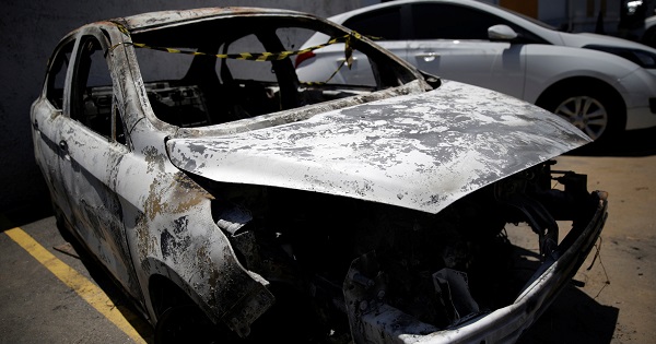 A burned car in which a body was found during searches for the Greek ambassador to Brazil, is pictured at a police station in Belford Roxo, Dec. 30, 2016.