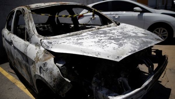 A burned car in which a body was found during searches for the Greek ambassador to Brazil, is pictured at a police station in Belford Roxo, Dec. 30, 2016. 