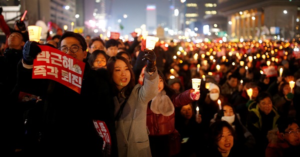 People attend a protest demanding Park Geun-hye's resignation in Seoul, South Korea, December 31, 2016. The sign reads 
