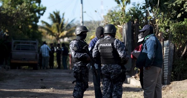 Policemen and investigators gather at a crime scene after a shooting at La fuente neighborhood in the town of Zaragoza, El Salvador, Feb. 8, 2016.