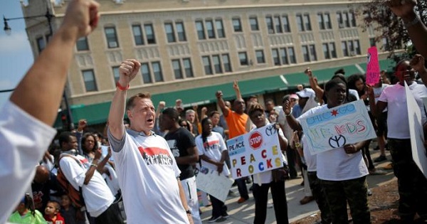 Father Michael Pfleger takes part in an anti-violence peace demonstration in a South Side neighborhood in Chicago, Illinois, Sept. 24, 2016.