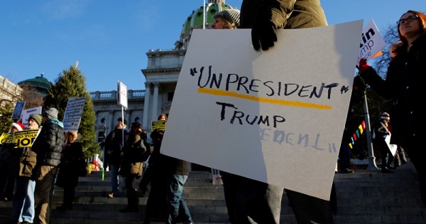 People protest against Donald Trump as electors gather to cast their votes for U.S. president at the Pennsylvania State Capitol in Harrisburg, Pennsylvania.