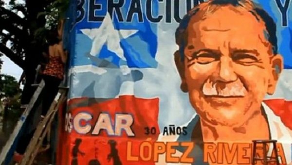 A woman works on a mural calling for the liberation of Oscar Lopez Rivera, San Juan, Puerto Rico.