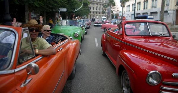 Tourists enjoy a ride in vintage cars in old Havana in this Jan. 17, 2016.