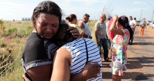 Relatives of prisoners reacts as they wait for news close to the Roraima state's largest penitentiary where at least 33 people were killed during a riot.
