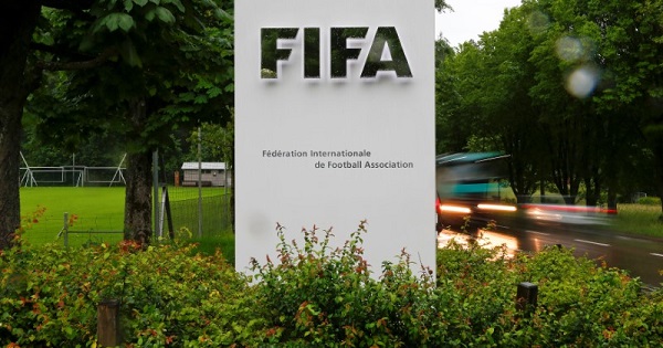Cars drive past a logo in front of FIFA's headquarters in Zurich, Switzerland, June 8, 2016.