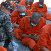 Detainees on arrival to Camp X-Ray, the holding facility at Guantanamo Bay, Cuba.