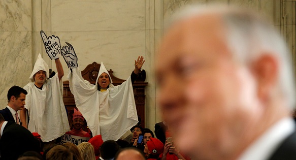 Protesters dressed as Klansmen disrupt the start of a confirmation hearing for U.S. Attorney General-nominee Jeff Sessions, Jan. 10, 2017.