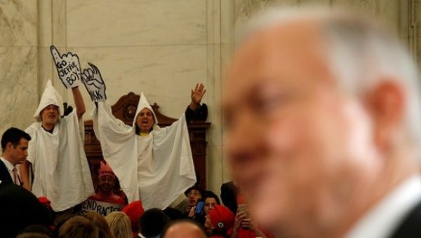 Protesters dressed as Klansmen disrupt the start of a confirmation hearing for U.S. Attorney General-nominee Jeff Sessions, Jan. 10, 2017.