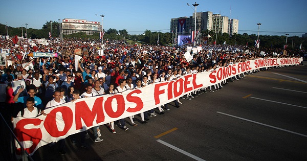 People march with a banner that reads 