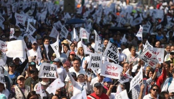 Protesters march during a demonstration against the rising prices of gasoline enforced by the Mexican government in Mexico City.