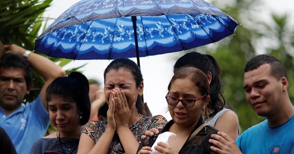 Relatives attend the funeral of one of the inmates who died during a prison riot, at the cemetery of Taruma in Manaus.