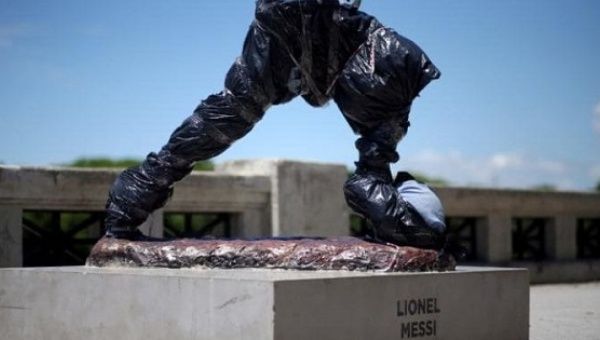 The statue of Argentina's soccer player Lionel Messi is seen covered after it was vandalized.