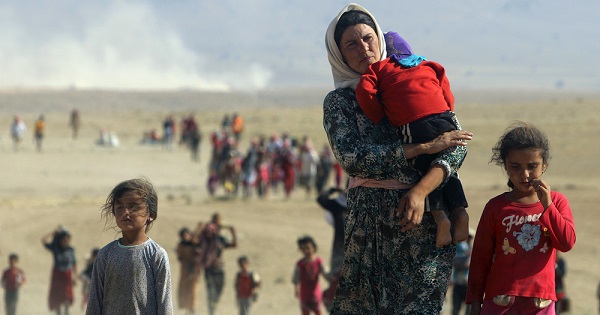 Displaced people from the minority Yazidi sect fleeing violence in Sinjar town, near the Syrian border, Aug. 11, 2014.